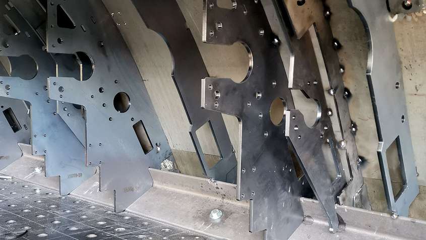 Close-up of multiple metal workpieces with many angled corners